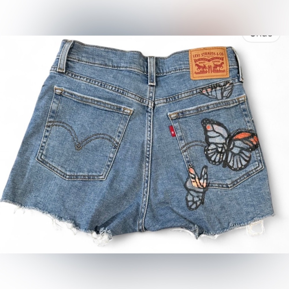 Levi's Blue Jean Shorts with Distressed Hem and Butterfly Accents